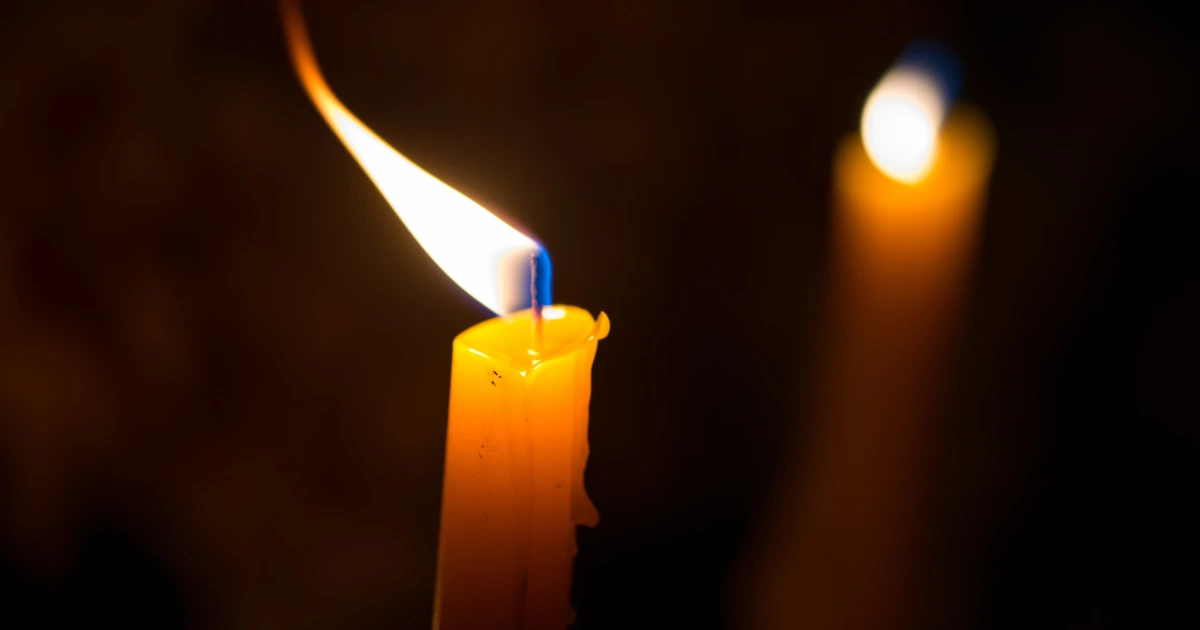 two candles burning signifying call for domestic violence reform